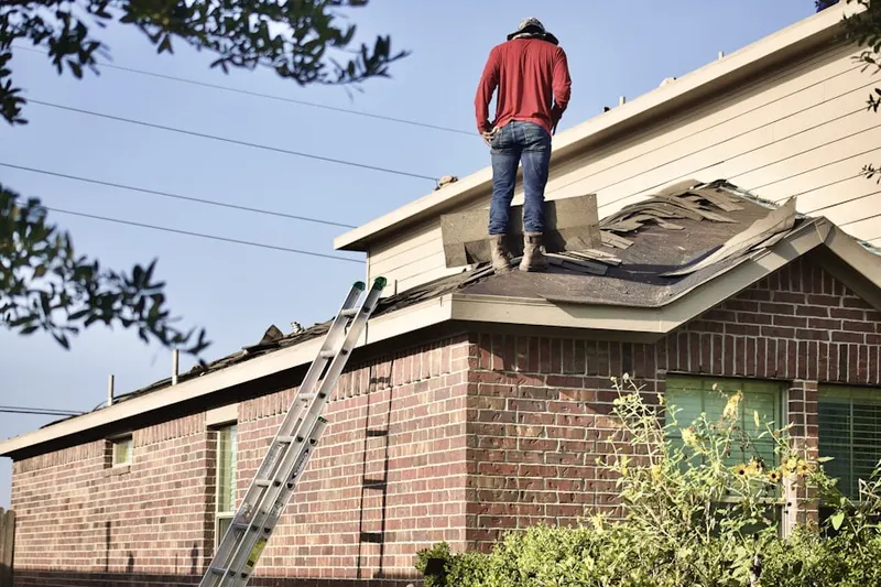 Professional roofer working on a residential roof in Spout Springs